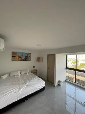 a bedroom with a large white bed and a window at Hotel La Estrella de David Cartagena in Cartagena de Indias