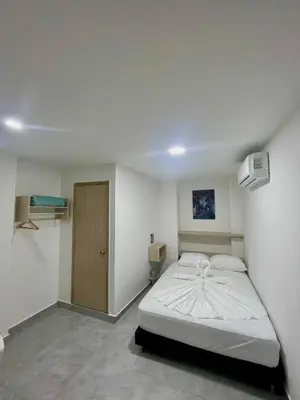 a bedroom with a white bed in a room at Hotel La Estrella de David Cartagena in Cartagena de Indias