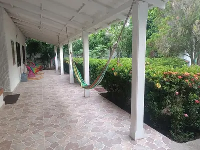 a porch with a hammock hanging from a roof at Casa Luna in Santa Veronica