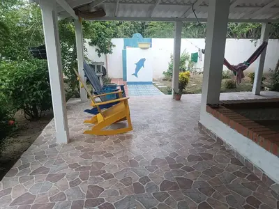 a patio with two rocking chairs and a swing at Casa Luna in Santa Veronica