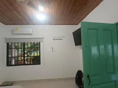 a room with a green door and a window at Casa Luna in Santa Veronica