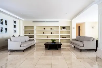 a living room with two chairs and a coffee table at Walled City apt- Rooftop Pool & Private Garden in Cartagena de Indias