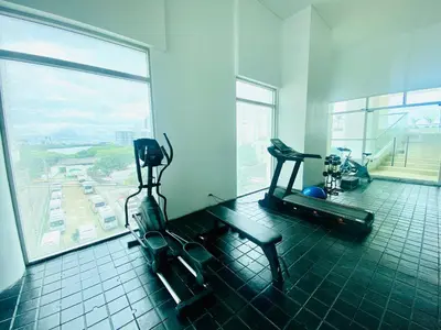 a gym with two tread machines and a large window at Melodias de Verano in Cartagena de Indias