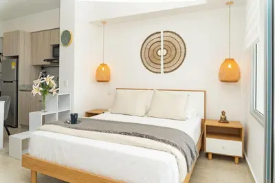 a bedroom with a bed and a kitchen at CB 1002 | Suite moderna con vista al mar infinita in Cartagena de Indias