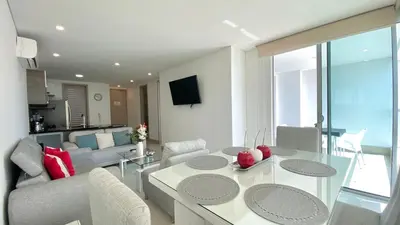 a living room with a glass table and a couch at Apartamento de una habitacion Palmetto Sunset 1703 in Cartagena de Indias