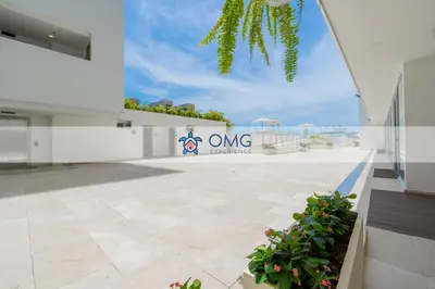 a large white building with a sign that reads one ownership at Suite moderna con WiFi rápido, balcón y vista CB1432 in Cartagena de Indias