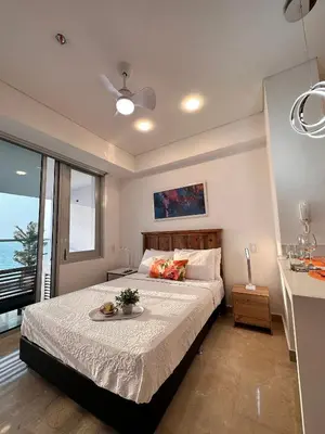 a bedroom with a bed with a view of the ocean at Despierta frente al mar mágicos atardeceres piso 15 CB1505 in Cartagena de Indias