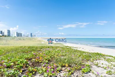a sign on a beach with flowers on it at Despierta frente al mar mágicos atardeceres piso 15 CB1505 in Cartagena de Indias