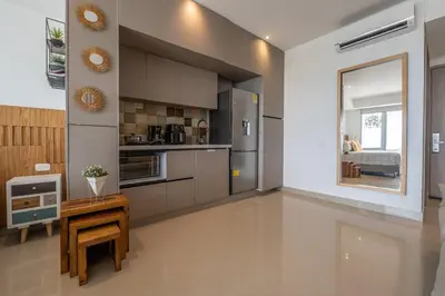 a kitchen with stainless steel appliances and a table at CB1531 | Confort premium: cama King y balcón in Cartagena de Indias