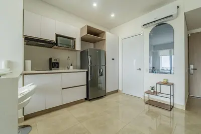 a kitchen with white cabinets and a stainless steel refrigerator at CB937 | Stylish loft piso 9 con balcón y vista ciudad in Cartagena de Indias
