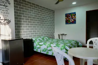 a bedroom with a bed and a table and chairs at Apartaestudios la terraza 1 in Sincelejo