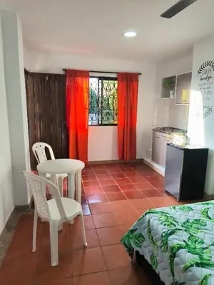 a room with a bed and a table and a kitchen at Apartaestudios la terraza 1 in Sincelejo