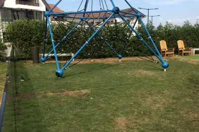 a blue swing set in a yard with chairs at Apartamento en la playa mas tranquila de Cartagena in Cartagena de Indias