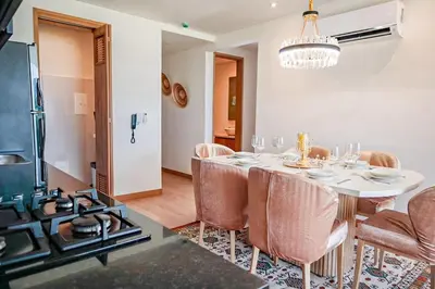 a dining room with a table with chairs and a chandelier at Dizztravel Apart Murano Centro Exclusivo apto 2701 in Cartagena de Indias