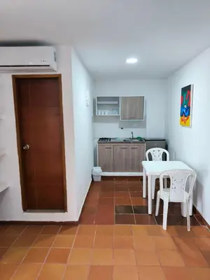 a kitchen with a table and chairs in a room at Apartaestudios la terraza 3 in Sincelejo