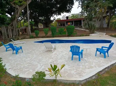 a group of chairs sitting around a swimming pool at campestre, naturaleza, confort, familiar in Turbaco