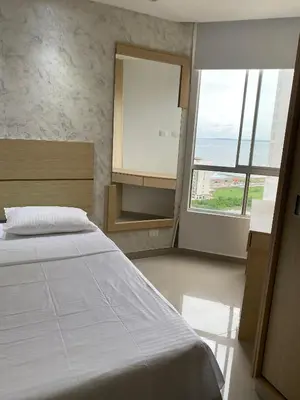 a bedroom with a bed and a large window at Apto para vacaciones en familia in Cartagena de Indias
