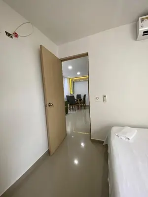 a room with a bed and a door to a dining room at Apto para vacaciones en familia in Cartagena de Indias