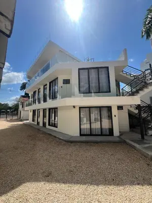 a large white building with the sun in the sky at Kiimala Villas y Hotel in Puerto Viejo