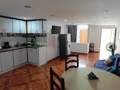 a kitchen with a table and a refrigerator at Apartamento Familiar para 6 personas in Cartagena de Indias