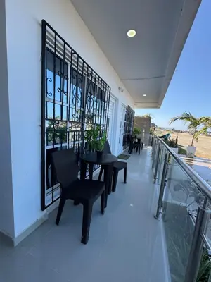 a balcony with a table and chairs on a building at Apartamentos el mochilero frente a la playa piso 1 apto 2 in Cartagena de Indias