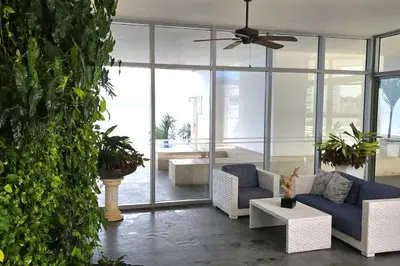 a living room with a blue couch and some plants at Apartamento Boutique - Cartagena in Cartagena de Indias