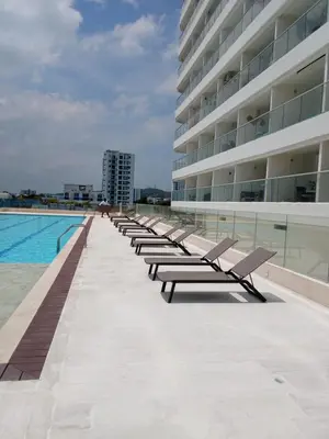 a row of benches next to a large building at Aparta suite Fantástique in Cartagena de Indias