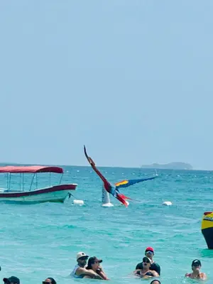 a group of people in the water with a boat at Aparta suite Fantástique in Cartagena de Indias