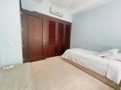 a bedroom with a bed and wooden cabinets at Modern Comfort - Spacious 2BR in Walled City in Cartagena de Indias
