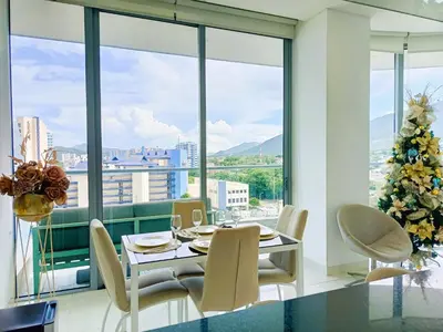 a dining room with a christmas tree and a table and chairs at Apartamento VIP - Con vistas al Mar y Playa in Santa Marta