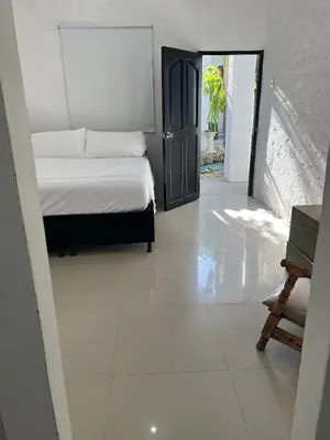 a bedroom with a bed and a white floor at Casa Torices Real 12 in Cartagena de Indias