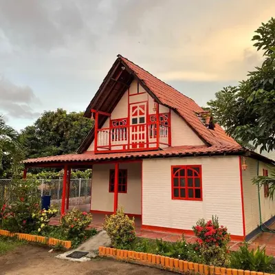 a small white house with a red roof at Biohotel Caribe Green in Santa Marta