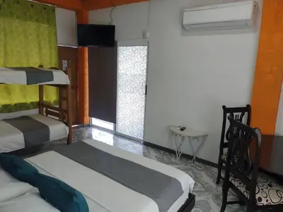 a room with two bunk beds and a window at Biohotel Caribe Green in Santa Marta