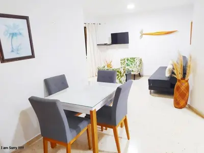 a dining room with a white table and chairs at Apartamento Piso 9 Vista al Mar in Cartagena de Indias