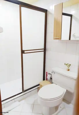 a white bathroom with a toilet and a window at Apartamento Piso 9 Vista al Mar in Cartagena de Indias