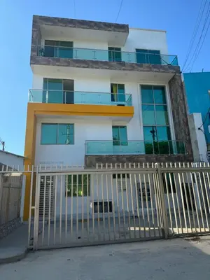 a white building with a fence in front of it at Rincón sereno barranquilla in Barranquilla
