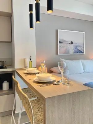 a dining room with a table and a bed at Suite moderna con vista al mar y parque CB 814 in Cartagena de Indias