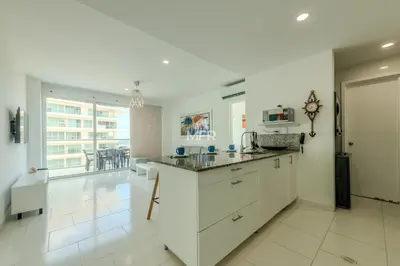 a kitchen with white cabinets and a counter top at Edificio Morros 3, Beachfront & 2 Bedrooms by Inmobiliaria MFR in Cartagena de Indias
