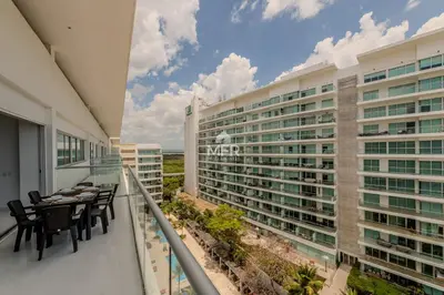 a balcony with tables and chairs and a building at Edificio Morros 3, Beachfront & 2 Bedrooms by Inmobiliaria MFR in Cartagena de Indias