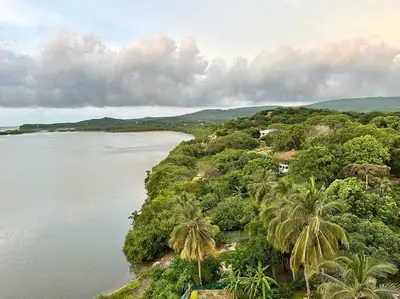 an island with palm trees and a body of water at Mirador del Mar Playa Mendoza in Tubará