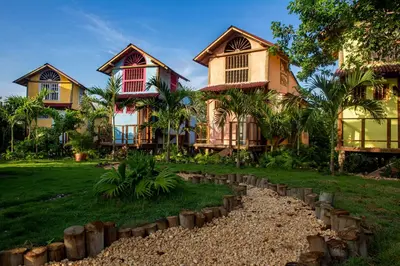 a group of houses with a grass yard at Tiny Village Cartagena Boutique Resort in Tierra Bomba