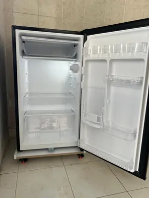 an empty refrigerator with its door open in a kitchen at Apartamento hostal oasis in Puerto Colombia