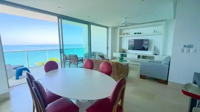 a living room with a table and chairs and a balcony at Magico Apartamento Frente al Mar 3 Habitaciones TR51 in Coveñas