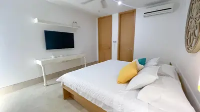 a white bedroom with a bed and a desk at Magico Apartamento Frente al Mar 3 Habitaciones TR51 in Coveñas