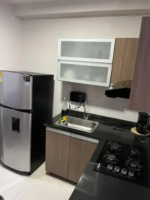 a kitchen with a stainless steel refrigerator and a sink at Barranquilla Villa Campestre Malecon Rio Uninorte in Barranquilla