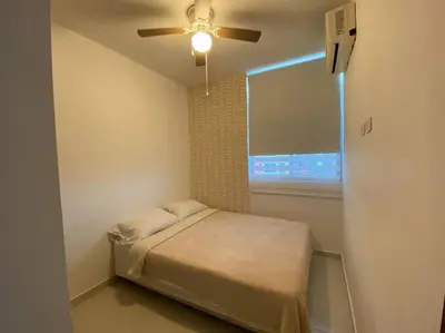 a bedroom with a bed and a ceiling fan at Barranquilla Villa Campestre Malecon Rio Uninorte in Barranquilla