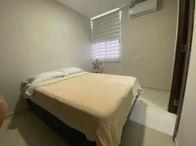 a white bedroom with a bed and a window at Barranquilla Villa Campestre Malecon Rio Uninorte in Barranquilla