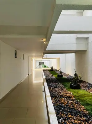 an empty hallway of an office building with plants at Ocean Luxe Morros in Cartagena de Indias