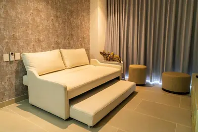 a living room with a chair and a couch at Lujoso Apartamento Baia Kristal in Cartagena de Indias