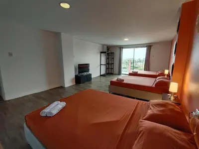 a hotel room with two beds and a television at Hotel Casa Harmony Cartagena in Cartagena de Indias